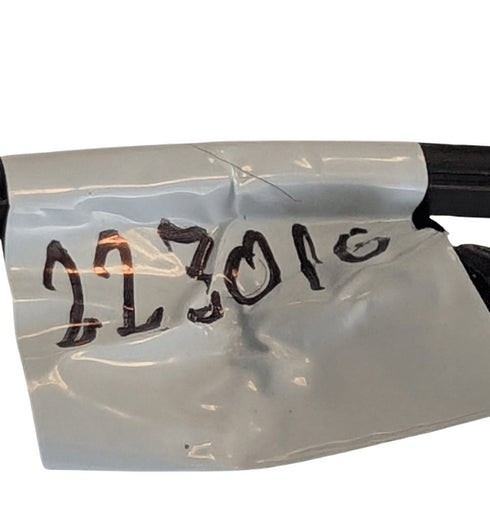 Clear plastic wrap with handwritten numbers '223010' on a white background